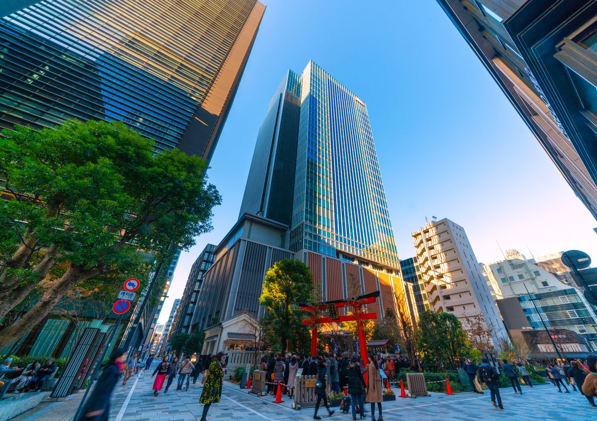 Modern Tokyo skyscrapers above a traditional shrine gate - Japan execution for APAC teams based in Singapore